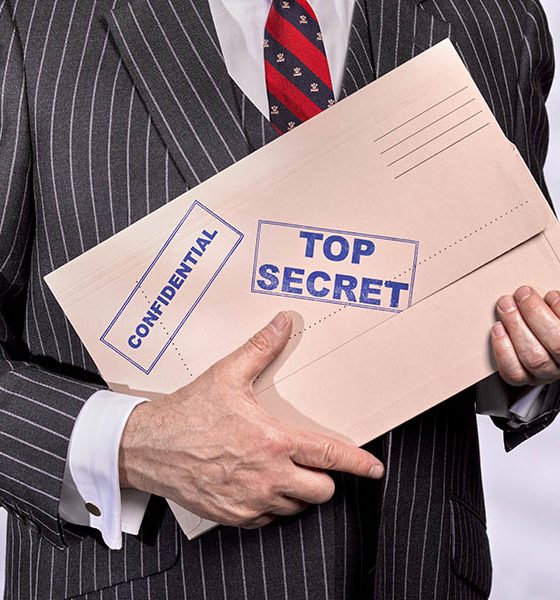 Guilty pleasures header image, man with top secret folder