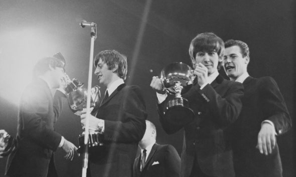 The Beatles with Roger Moore at the 1963 NME Poll Winners Concert. Photo: Mark and Colleen Hayward/Redferns