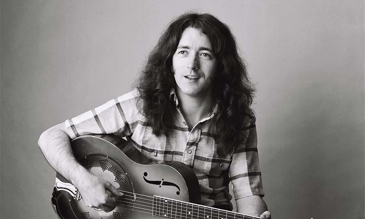 Rory Gallagher playing guitar