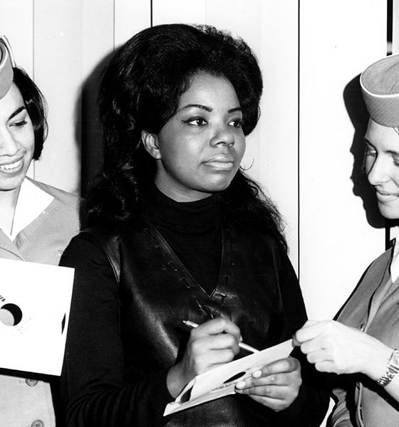 Photo of Mary Wells signing an autograph