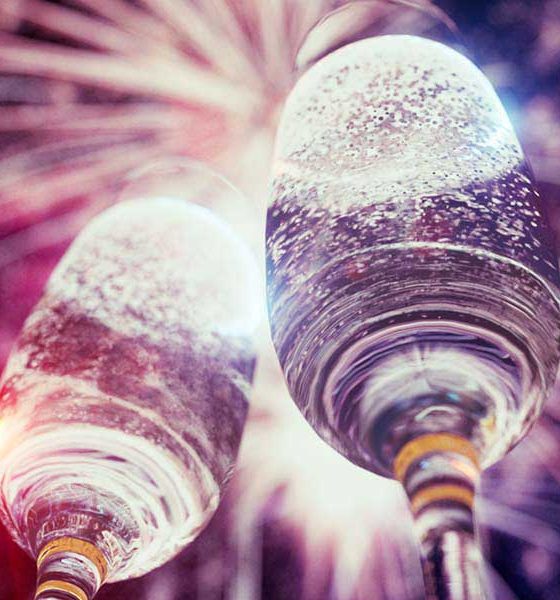Best Classical Music for New Year - featured image of champagne glasses and fireworks