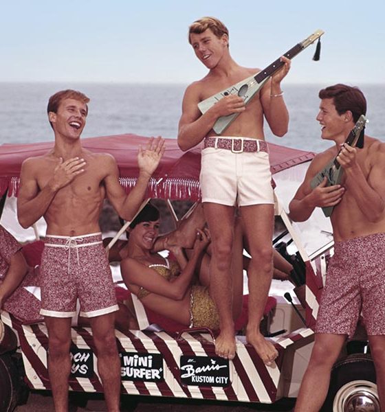 Folks playing surf rock music on a beach