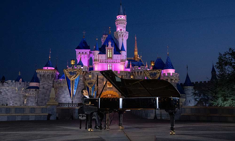 Lang Lang filming the music video for his new single ‘Feed the Birds’ at sunrise in front of Sleeping Beauty Castle at Disneyland Park in California