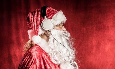 Christmas Santa listening to rock music on headphones