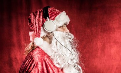 Christmas Santa listening to rock music on headphones