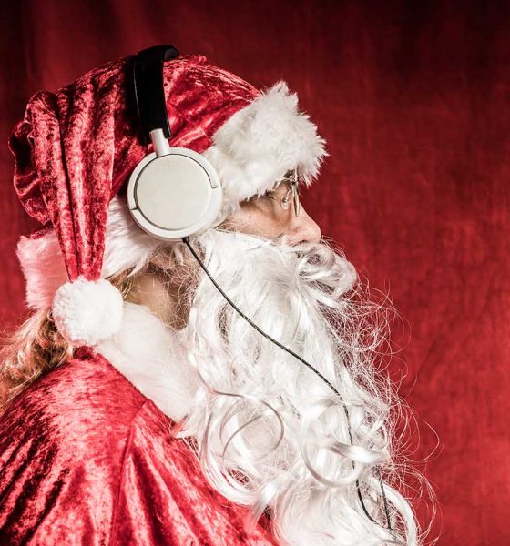 Christmas Santa listening to rock music on headphones