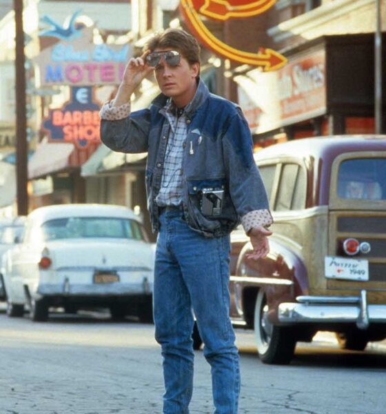 Michael J Fox walking across the street in a scene from the film 'Back To The Future', a movie with a classic 1980s soundtrack